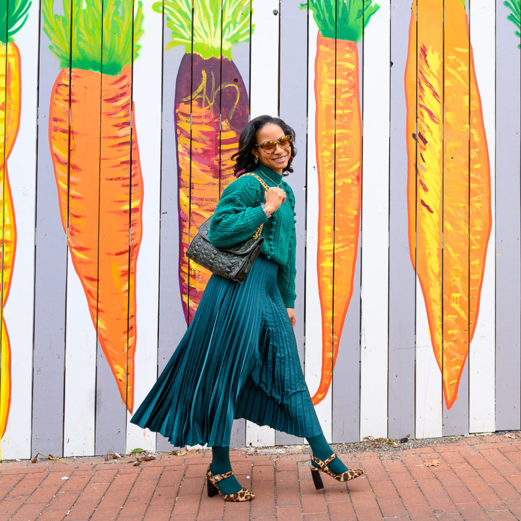 emerald outfit with a hint of leopard consisting of green sezane sweater, emerald midi skirt and leopard high heel shoes