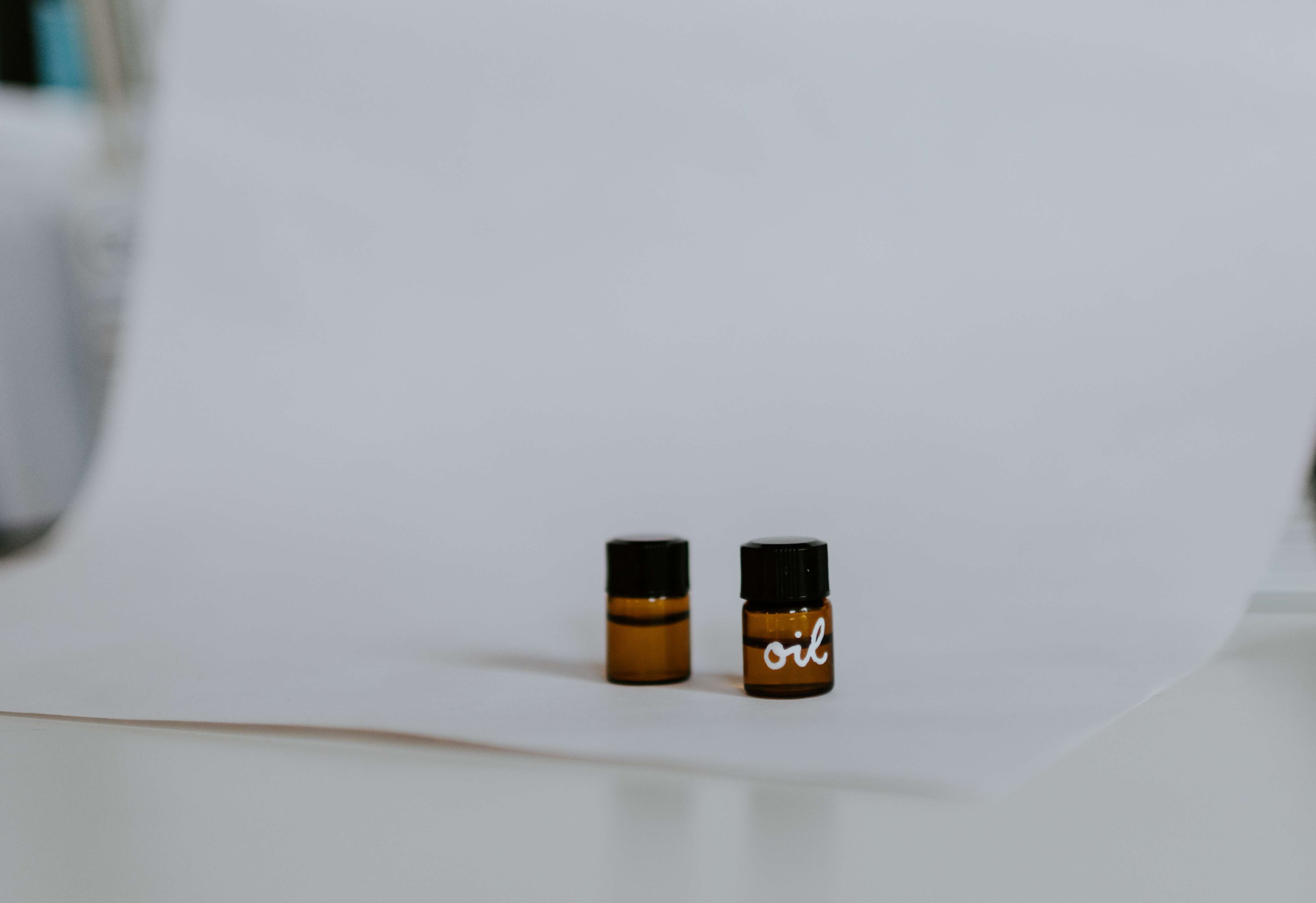 Two small vials of oil. Photo by Kelly Sikkema on Unsplash